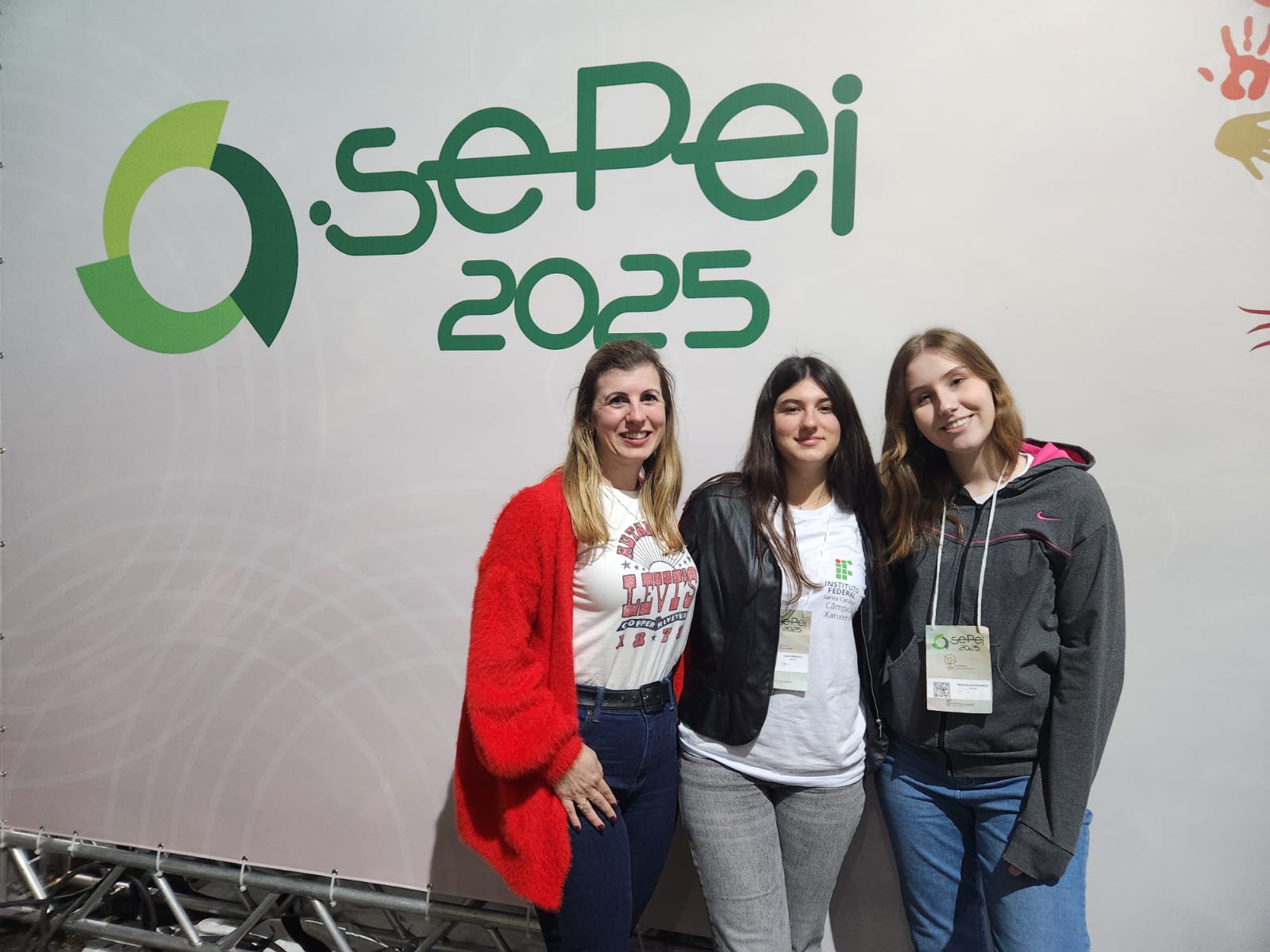 Sara Perrucci (ao centro) no Sepei, com a coordenadora de Extensão e Relações Externas do Câmpus Xanxerê, Geslene Agostini Sofiatti (de vermelho), e a colega Manuella Bonamigo, cuja família está hospedando Sara durante o intercâmbio